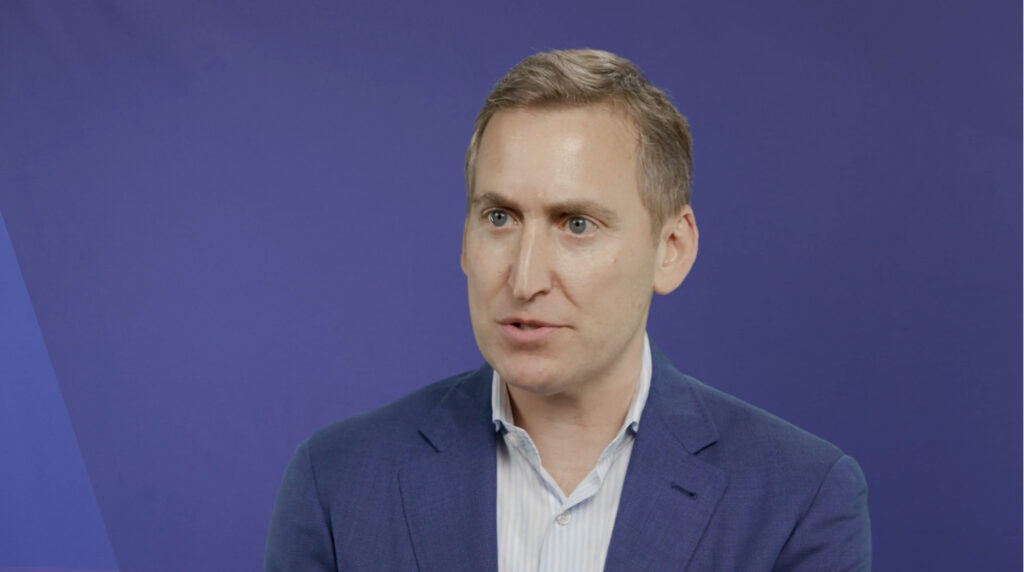 Individual looking off in front of a purple background